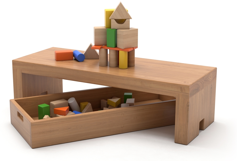 Wooden bench with a construction of toy blocks, more blocks in the crate